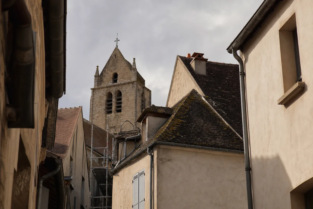 Toits en tuiles du centre ancien de Longjumeau vus depuis une rue étroite